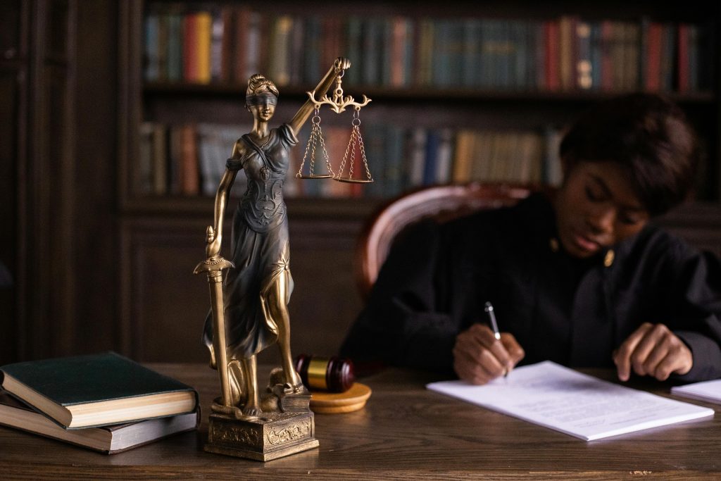 African lawyer studying by a statue.