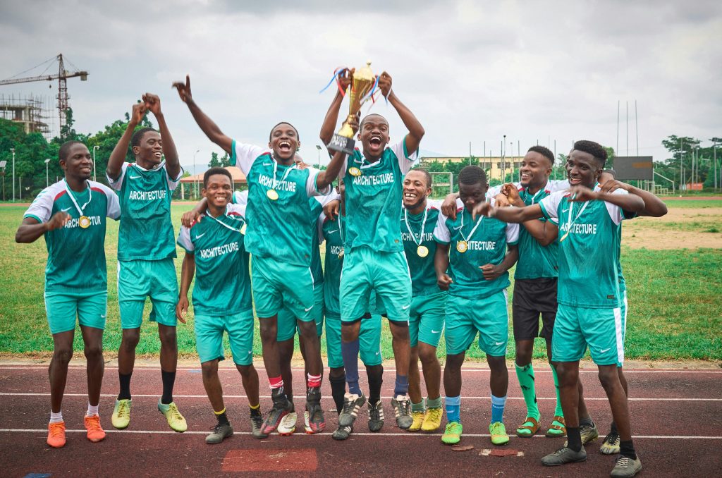 football team holding a trophy.